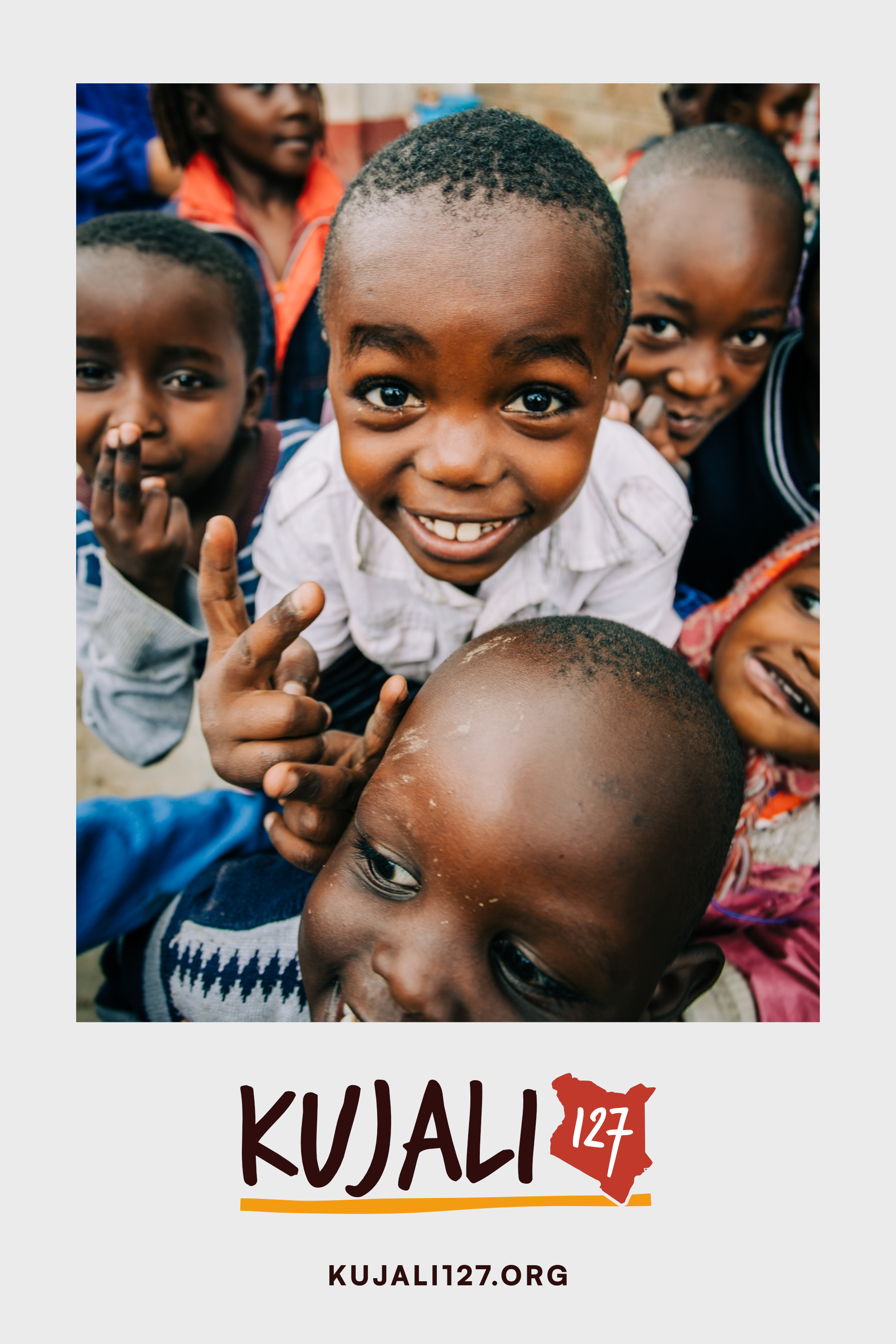 Kujali127 campaign poster featuring smiling children and the Kujali127 identity